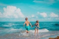 little girl and boy run and play with water at beach Royalty Free Stock Photo