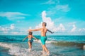 little girl and boy run and play with water at beach Royalty Free Stock Photo