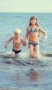 Little girl and boy in the sea Royalty Free Stock Photo