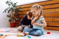 Little girl and boy sitting on floor and playing with constructor lego in kindergarten. Children playing games with toys Royalty Free Stock Photo