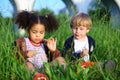 Little girl and boy sitting pensively in the tall