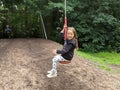 Little girl and boy sliding down a zip wire Royalty Free Stock Photo