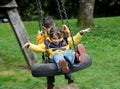 Little girl and boy swing Royalty Free Stock Photo