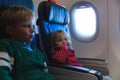 Little girl and boy travel by plane Royalty Free Stock Photo