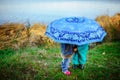 Little girl and boy with umbrella playing in the rain. Kids play outdoor by rainy weather in fall. Autumn fun for children. Toddle Royalty Free Stock Photo