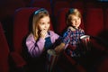 Little girl and boy watching a film at a movie theater Royalty Free Stock Photo