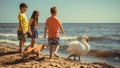 Little girl boys kids on beach have fun with swan. Royalty Free Stock Photo