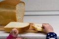 Little girl breaks bread on a close-up table