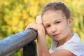 Little girl on a bridge in early fall park Royalty Free Stock Photo