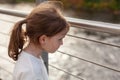 little girl with on the bridge over the river, autumn day