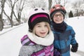 Little girl and brother enjoying ice skating in winter season Royalty Free Stock Photo