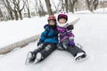 Little girl and brother enjoying ice skating in winter season Royalty Free Stock Photo