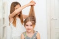 Little girl brushing hair of her younger sister Royalty Free Stock Photo