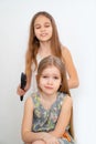 Little girl brushing hair of her younger sister Royalty Free Stock Photo