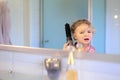 Little girl brushing her hair Royalty Free Stock Photo