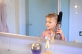 Little girl brushing her hair Royalty Free Stock Photo