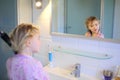 Little girl brushing her hair Royalty Free Stock Photo