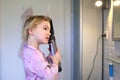 Little girl brushing her hair Royalty Free Stock Photo