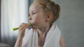 Little girl brushing her teeth diligently, dental hygiene, morning ritual