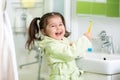 Little girl brushing teeth in bath Royalty Free Stock Photo