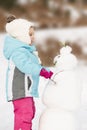 Little girl building a snowman Royalty Free Stock Photo