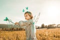 Little girl in a butterfly costume with wings in the field Royalty Free Stock Photo