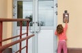 Little girl calling in on-door speakerphone