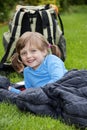 Little girl camping laying on a sleaping bag