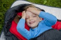 Little girl camping with sleeping bag Royalty Free Stock Photo