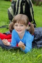 Little girl camping with sleeping bag Royalty Free Stock Photo