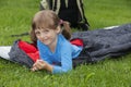 Little girl camping with sleeping bag Royalty Free Stock Photo