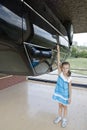 Little girl with the car in attraction Inverted house.