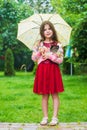 Little girl carry cute kitten cat under umbrella, love and care concept Royalty Free Stock Photo