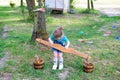 Little girl with a carrying pole and two buckets. Royalty Free Stock Photo