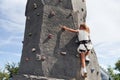 Little girl in casual white clothes training rock climbing outdoors Royalty Free Stock Photo