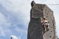 Little girl in casual white clothes training rock climbing outdoors Royalty Free Stock Photo