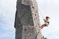 Little girl in casual white clothes training rock climbing outdoors Royalty Free Stock Photo