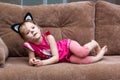 Little girl with cat face painting on couch Royalty Free Stock Photo