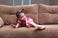 Little girl with cat face painting on couch Royalty Free Stock Photo