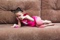 Little girl with cat face painting play ball on couch Royalty Free Stock Photo