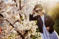 Little girl with a cat hat and black sunglasses in early spring in sunny weather Royalty Free Stock Photo