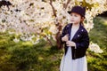 Little girl with a cat hat walking in the city in early spring in sunny weather Royalty Free Stock Photo