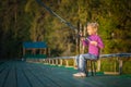 Little girl catches fishing rod Royalty Free Stock Photo