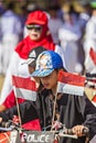 A little girl celebrate Indonesian Independence day, bring Indonesian flag the red and white flag in the bicycle