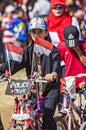 A little girl celebrate Indonesian Independence day, bring Indonesian flag the red and white flag in the bicycle