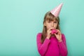 Little girl celebrating birthday blowing a balloon Royalty Free Stock Photo
