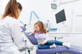 Little girl in chair visiting dentist