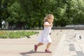 Little girl chasing pigeons in summer park Royalty Free Stock Photo