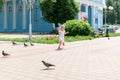 Little girl chasing pigeons in summer park Royalty Free Stock Photo