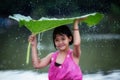 The little girl cheerful playing raining